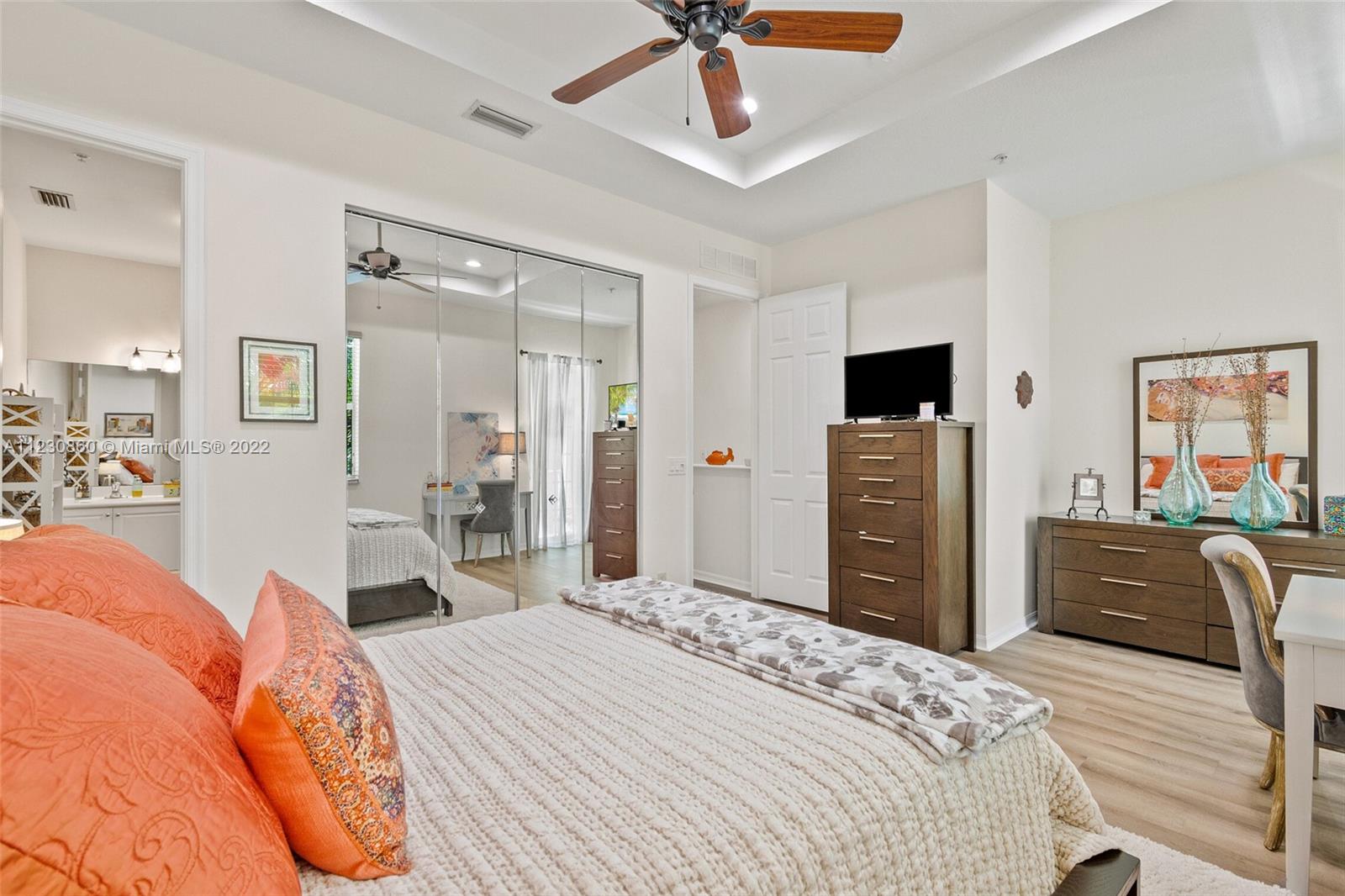 4332 Main Street Jupiter, FL 33458 - Photo 17 of 28 a bedroom with a bed dresser and a flat tv screen