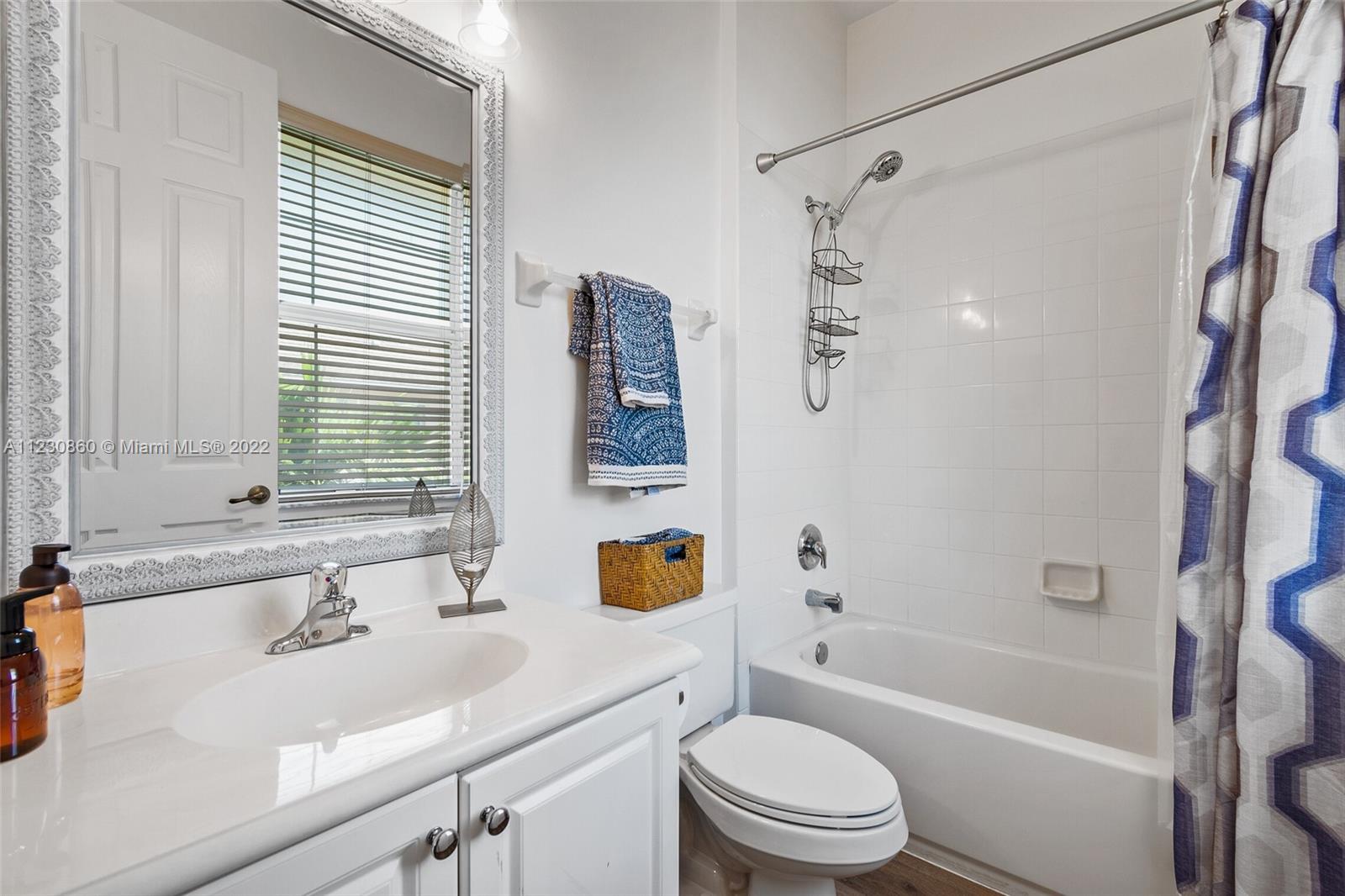 4332 Main Street Jupiter, FL 33458 - Photo 21 of 28 a bathroom with a sink a toilet and a bathtub