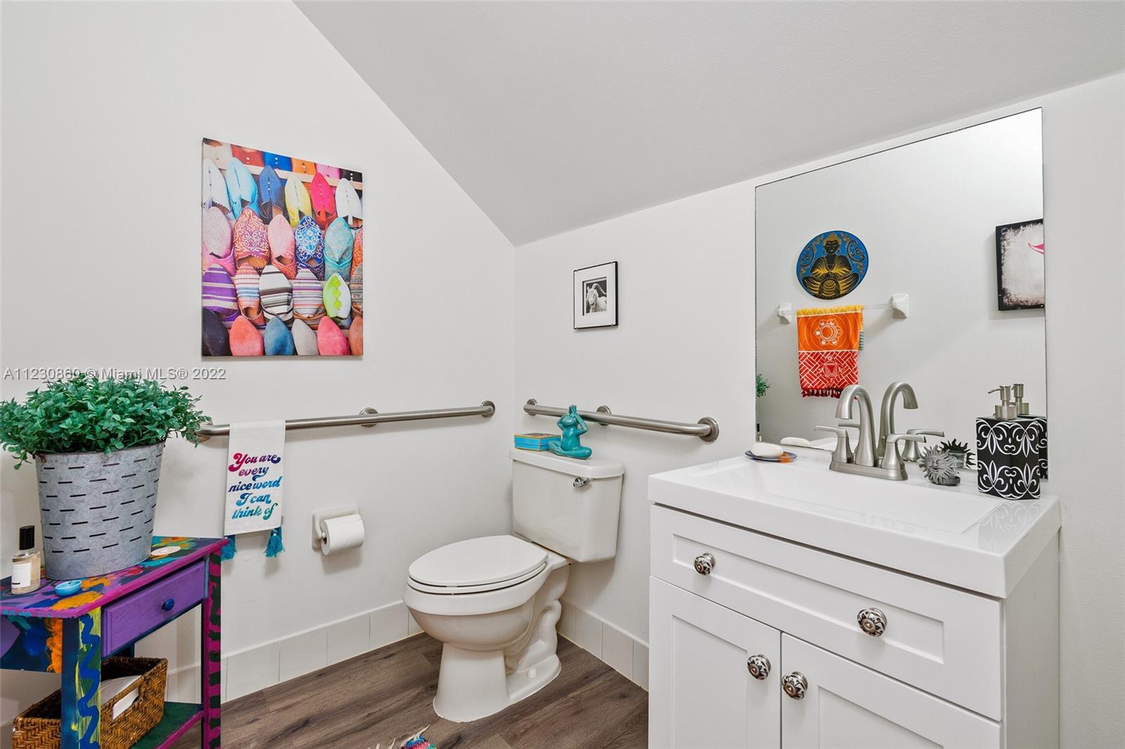 4332 Main Street Jupiter, FL 33458 - Photo 6 of 28 a bathroom with a sink mirror vanity and toilet