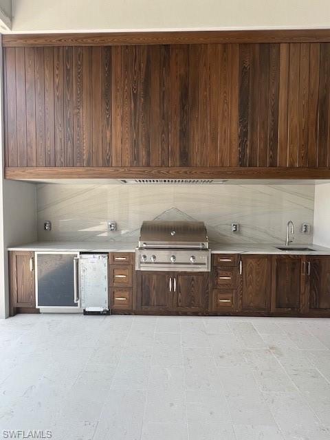 560 Rudder Road Naples, FL 34102 - Photo 15 of 23 a kitchen with stainless steel appliances granite countertop wooden cabinets a sink and dishwasher