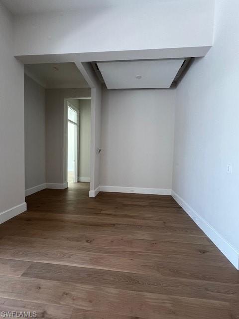 560 Rudder Road Naples, FL 34102 - Photo 20 of 23 a view of an empty room with wooden floor and a window