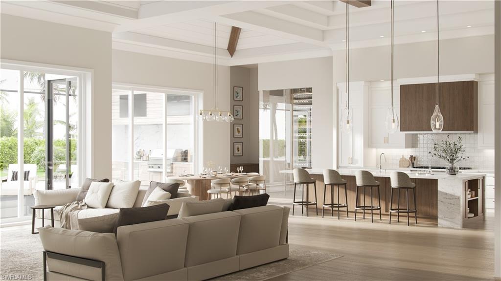 560 Rudder Road Naples, FL 34102 - Photo 5 of 23 a living room with furniture wooden floor and a large window