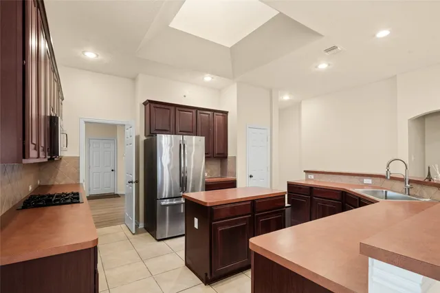 a kitchen with a refrigerator and a sink