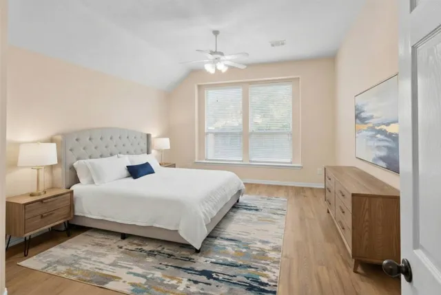 a bedroom with a large bed and a fireplace