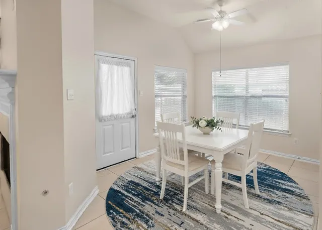 a dining room with furniture and window