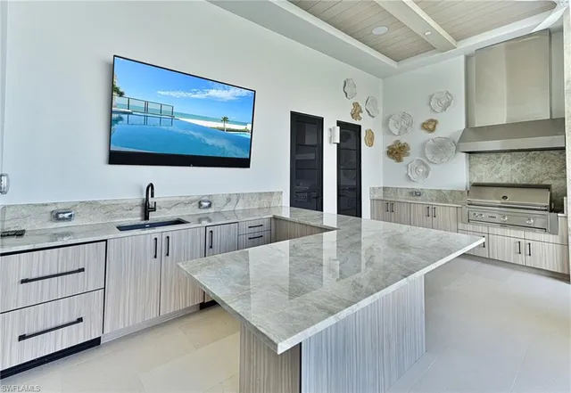 a kitchen with stainless steel appliances granite countertop a sink a stove and a refrigerator
