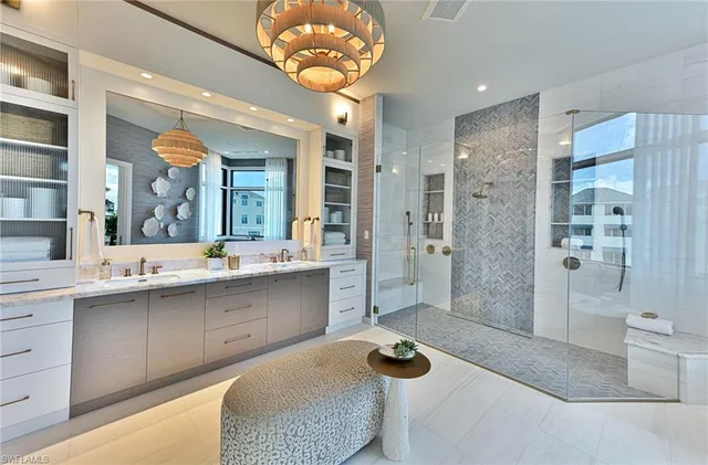 a bathroom with a sink a toilet a mirror and shower