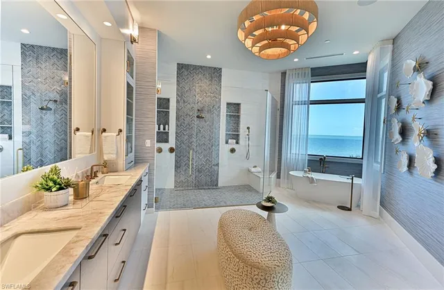 a spacious bathroom with a granite countertop tub sink and mirror