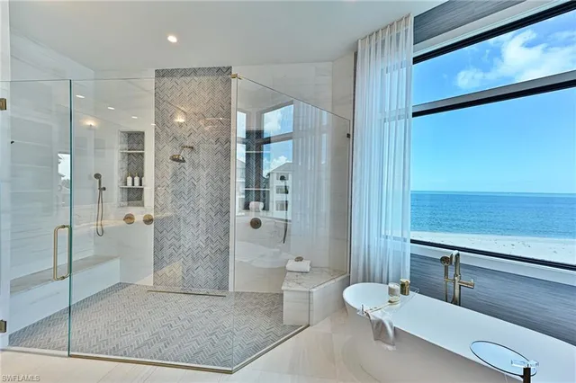 a spacious bathroom with a shower a sink and a mirror