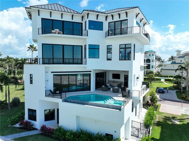 a front view of residential houses with yard
