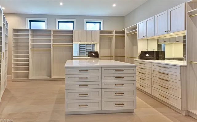 a kitchen with cabinets appliances and a window