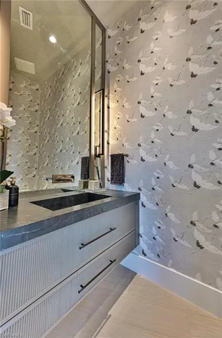 a bathroom with a sink and a mirror