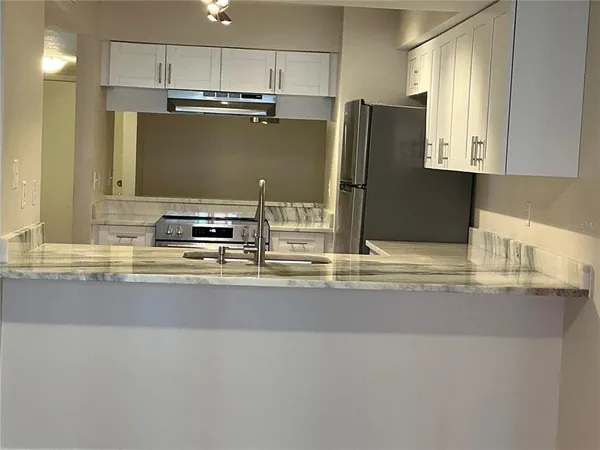 a kitchen with a sink cabinets and window