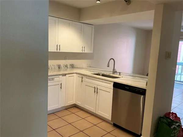 a kitchen with a sink and refrigerator