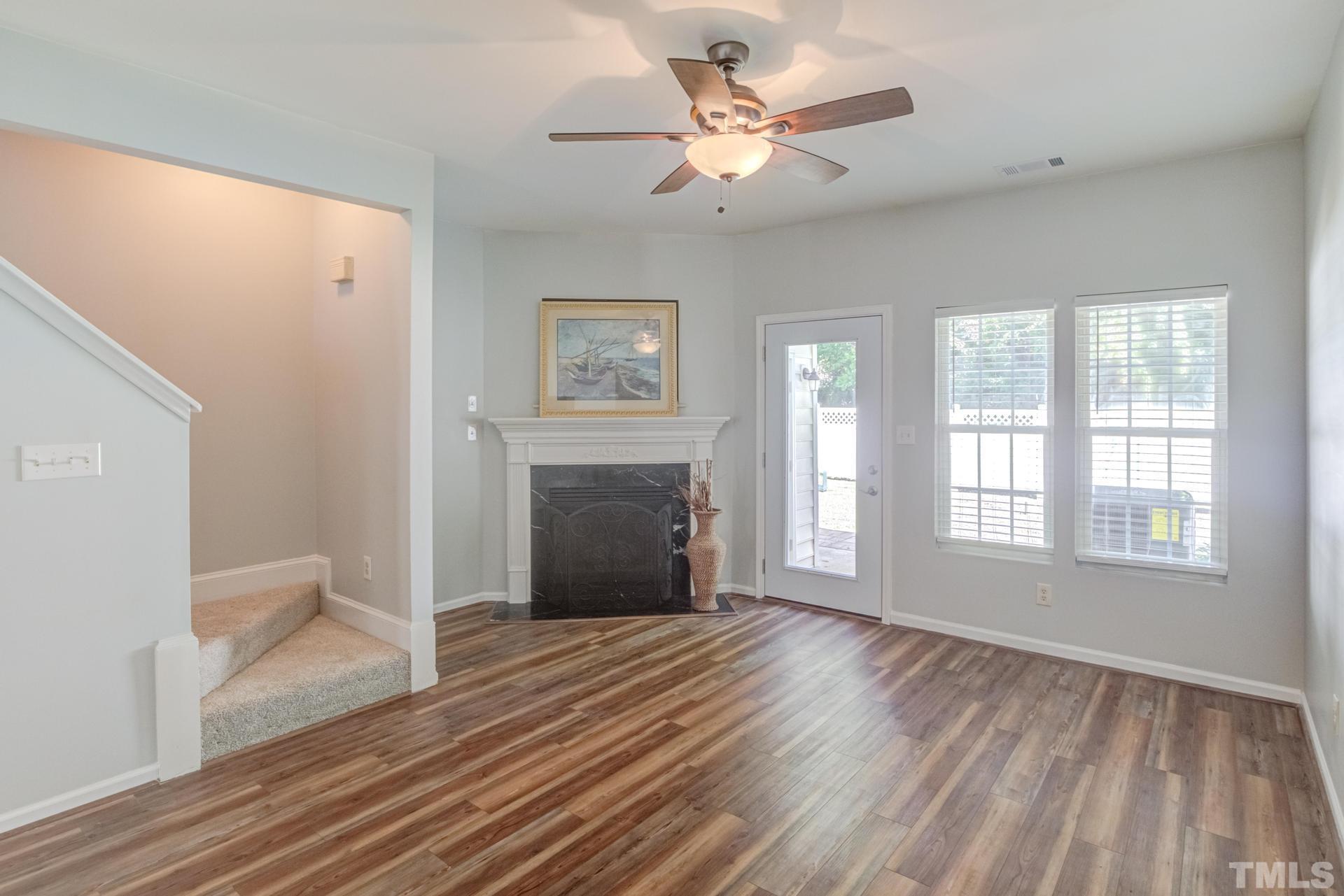 705 Glen Road, Unit 103 Garner, NC 27529 - Photo 12 of 25 a view of an empty room with a window and wooden floor