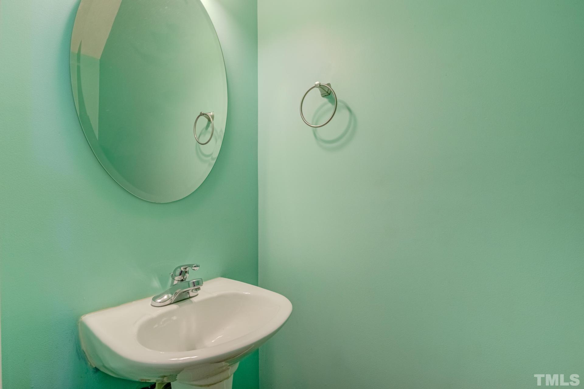 705 Glen Road, Unit 103 Garner, NC 27529 - Photo 14 of 25 a bathroom with a sink and mirror