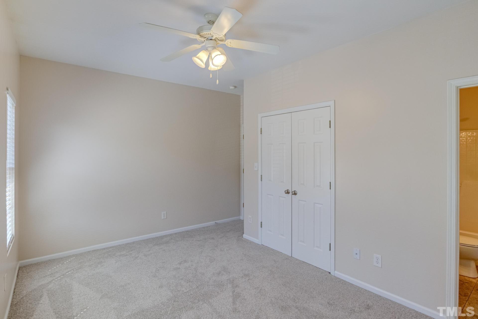 705 Glen Road, Unit 103 Garner, NC 27529 - Photo 16 of 25 an empty room with windows and fan