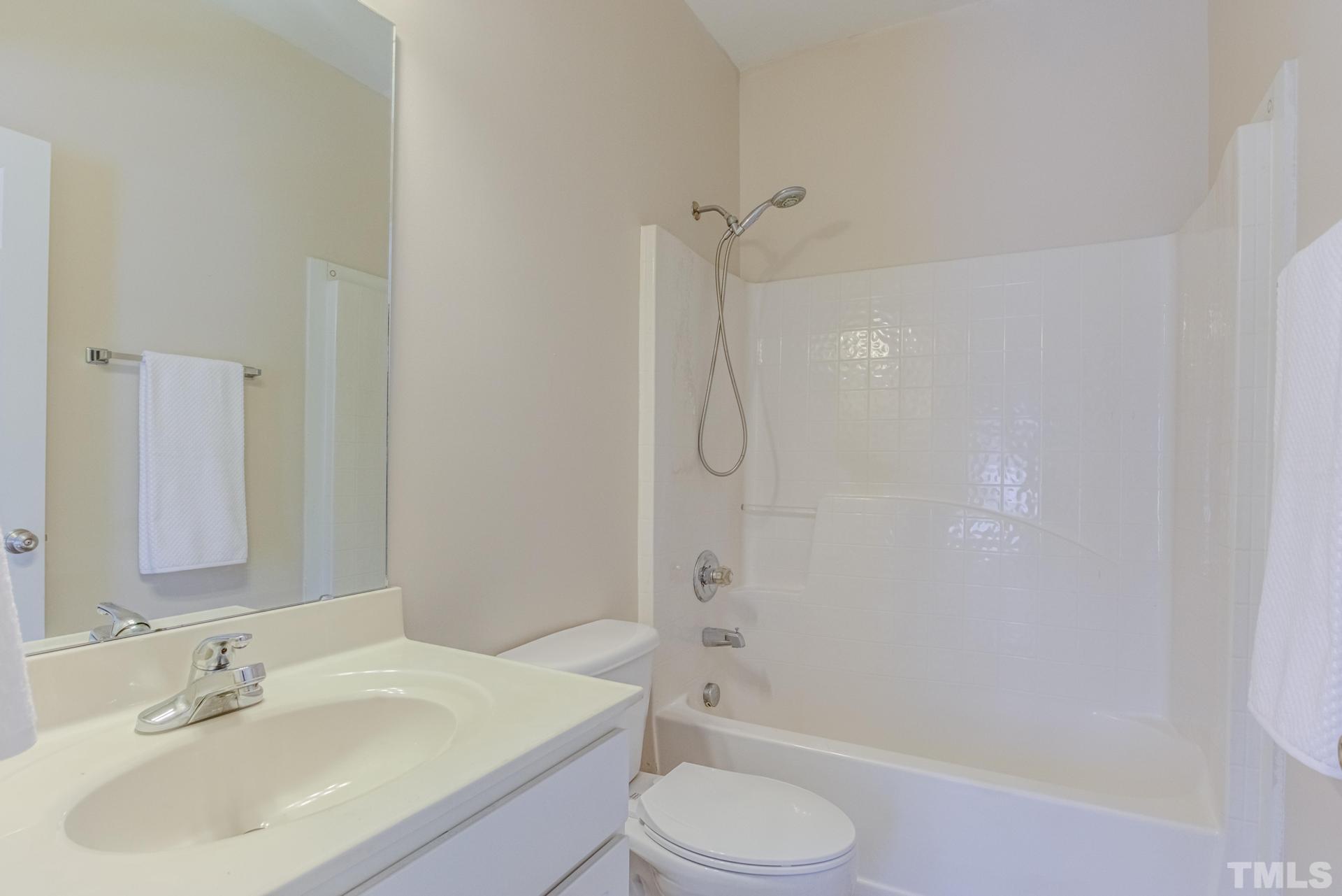 705 Glen Road, Unit 103 Garner, NC 27529 - Photo 18 of 25 a bathroom with a sink toilet and shower