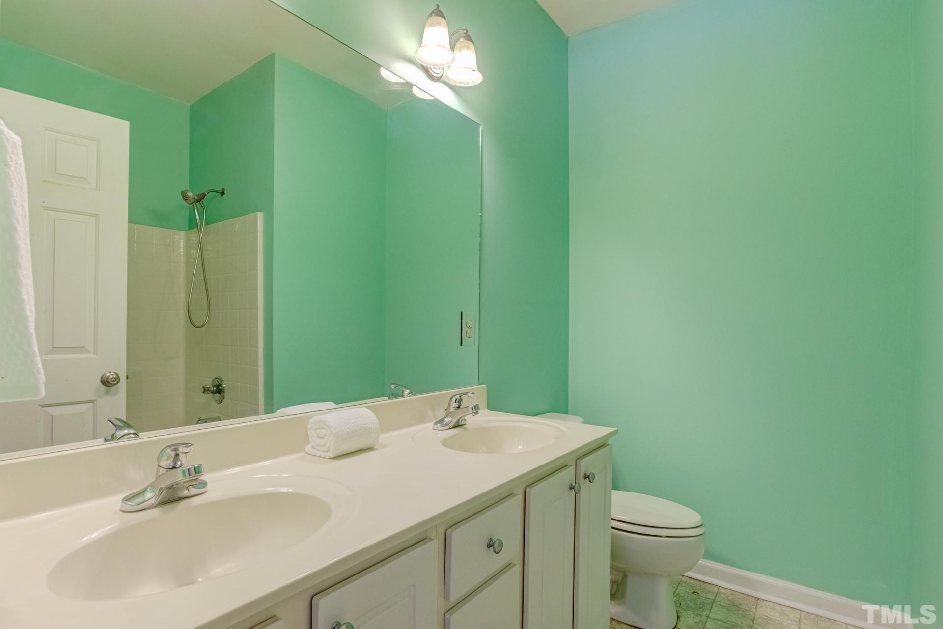 705 Glen Road, Unit 103 Garner, NC 27529 - Photo 22 of 25 a bathroom with a sink and a mirror