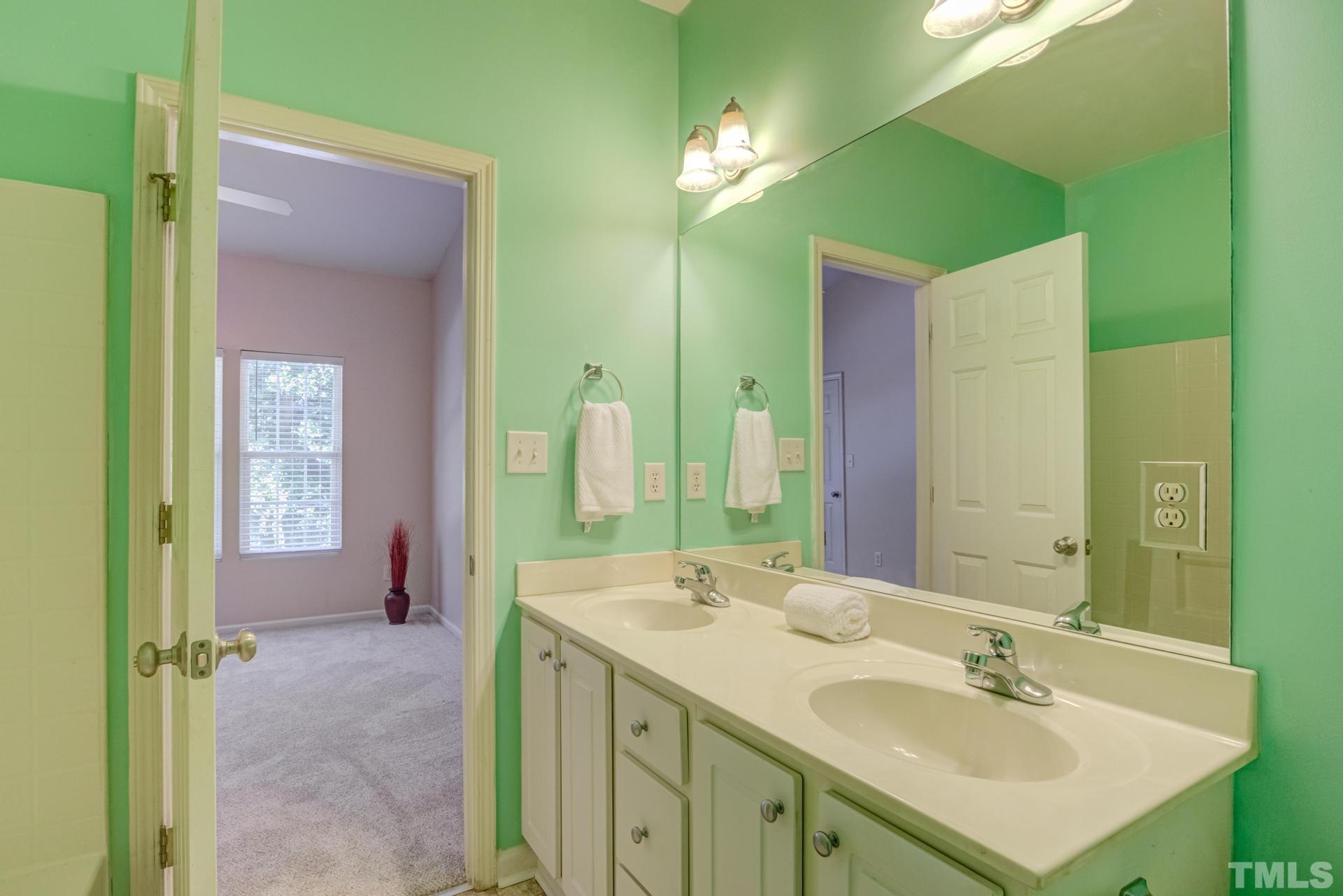 705 Glen Road, Unit 103 Garner, NC 27529 - Photo 23 of 25 a bathroom with a sink vanity and a mirror