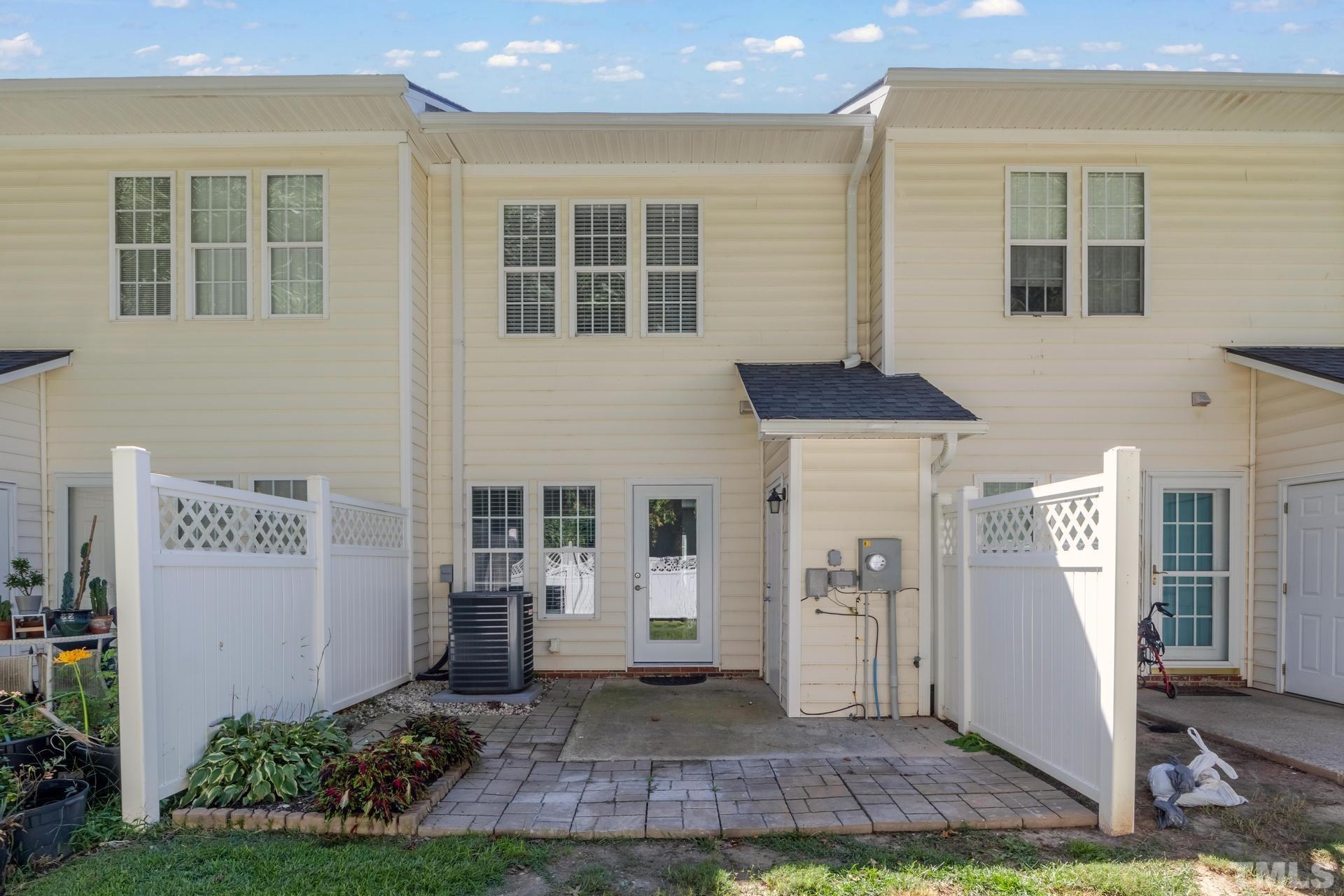 705 Glen Road, Unit 103 Garner, NC 27529 - Photo 25 of 25 a front view of a house with a yard and outdoor seating