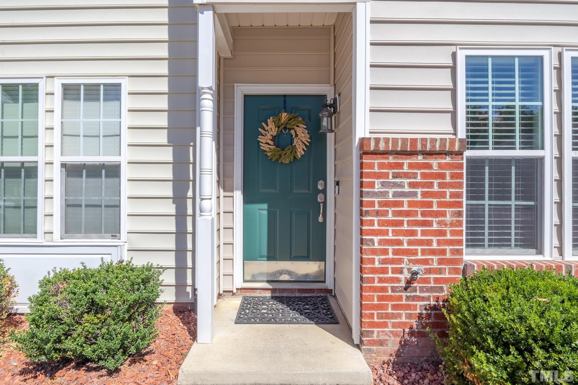 705 Glen Road, Unit 103 Garner, NC 27529 - Photo 3 of 25 a front view of a house with a garden