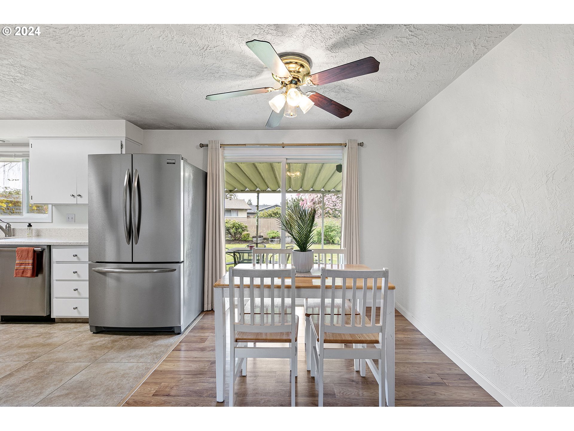2484 19th Street Springfield, OR 97477 - Photo 11 of 30 a kitchen with a refrigerator and a wooden cabinets
