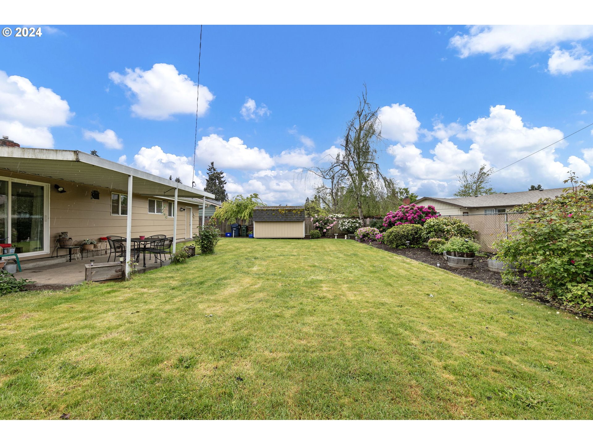 2484 19th Street Springfield, OR 97477 - Photo 25 of 30 a backyard of a house with table and chairs