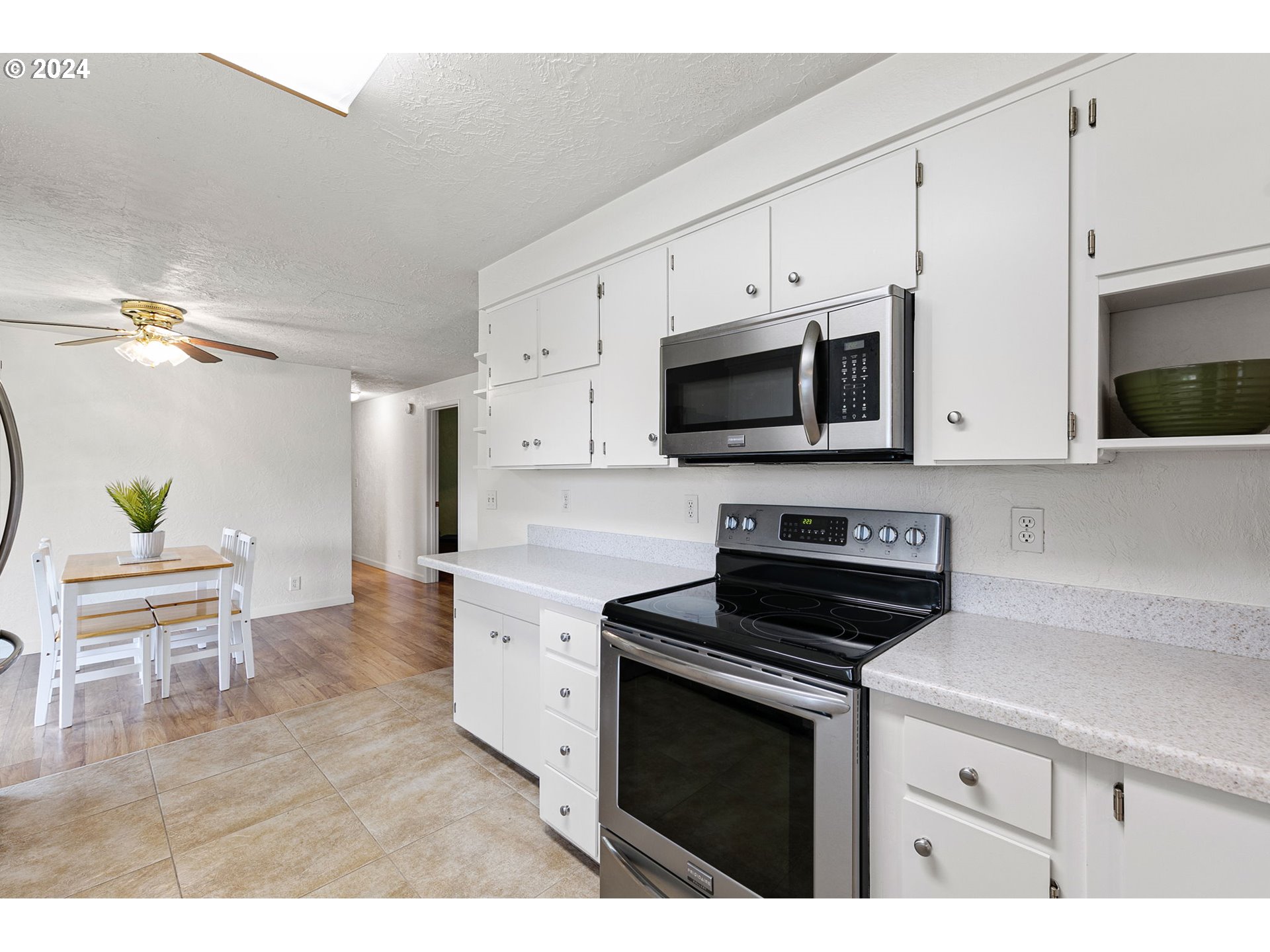 2484 19th Street Springfield, OR 97477 - Photo 9 of 30 a kitchen with stainless steel appliances a stove microwave and cabinets