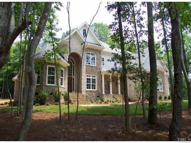 1025 Quiet Ridge Circle Raleigh, NC 27614 - Photo 1 of 1 a view of a brick house next to a yard with big trees