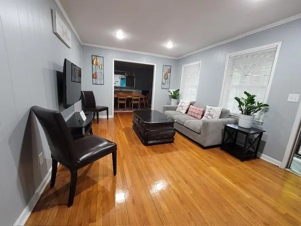 a living room with furniture flat screen tv and a fireplace