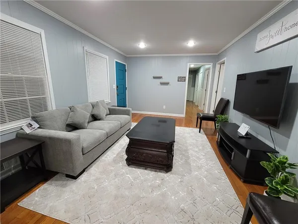 a living room with furniture and a flat screen tv