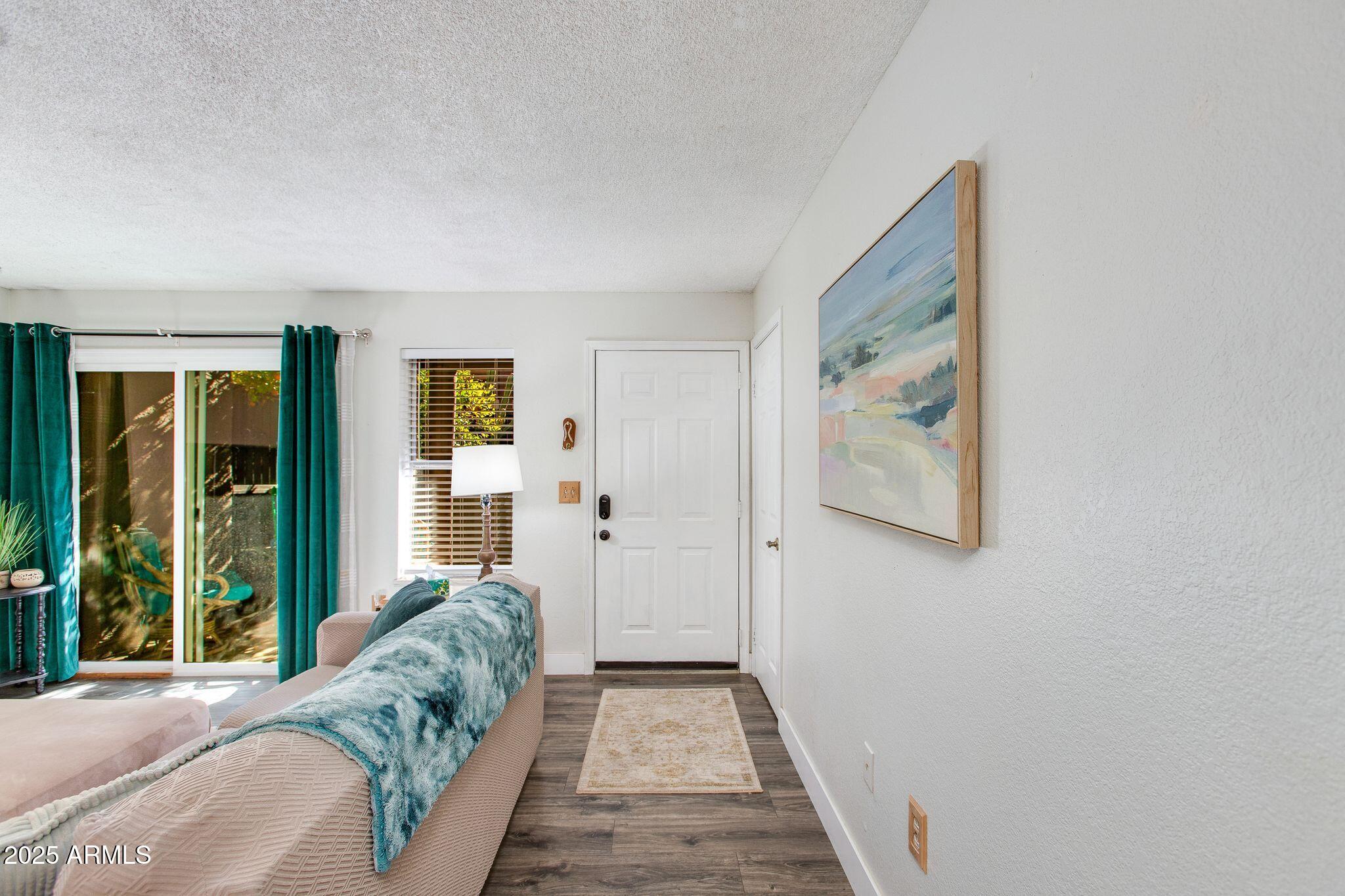 1645 West Baseline Road, Unit 1058 Mesa, AZ 85202 - Photo 14 of 44 a hallway with a large window and couch