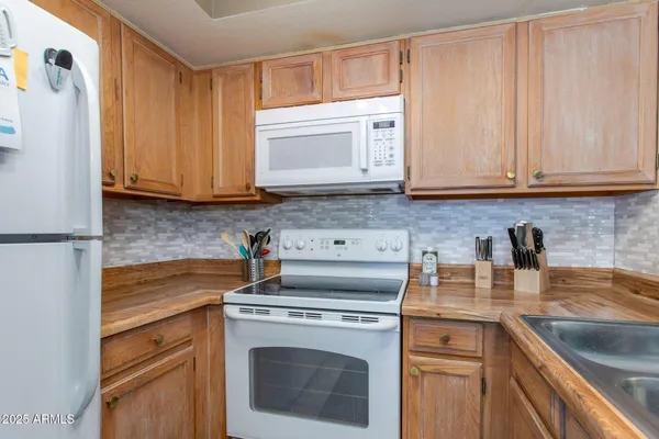 a kitchen with a sink stove and refrigerator