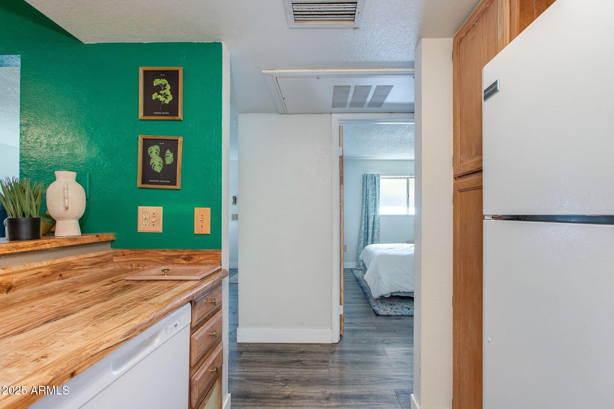 1645 West Baseline Road, Unit 1058 Mesa, AZ 85202 - Photo 29 of 44 a bedroom with a bed and a lamp on table