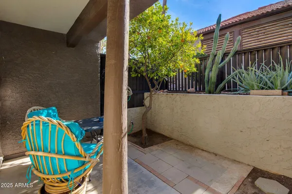 a backyard of a house with table and chairs