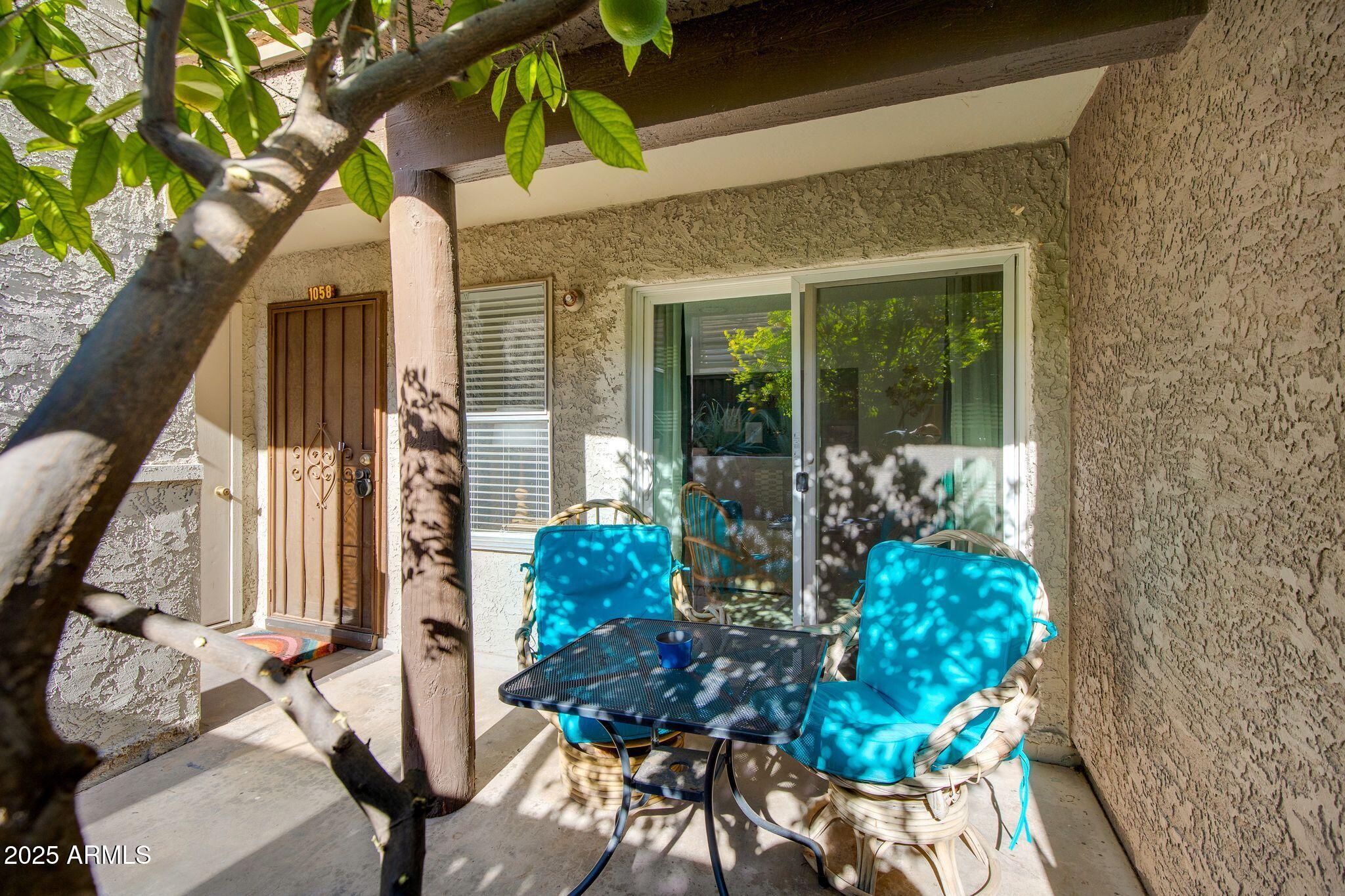 1645 West Baseline Road, Unit 1058 Mesa, AZ 85202 - Photo 10 of 44 a front view of a house with patio