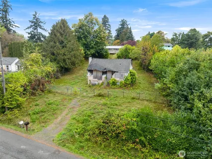 an aerial view of a house with garden space and street view