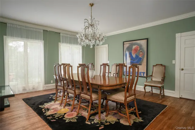 a dining room with furniture a rug a rug and a chandelier