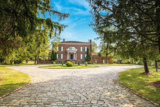 a view of swimming pool in big yard with large trees
