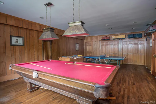 a view of a swimming pool with a patio and a yard