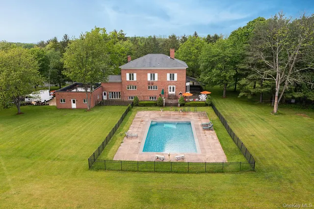 a front view of house with yard and outdoor seating