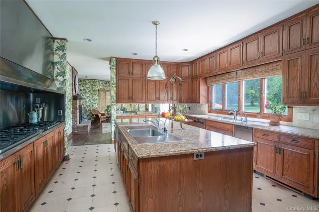 a kitchen with counter top space a sink appliances and cabinets