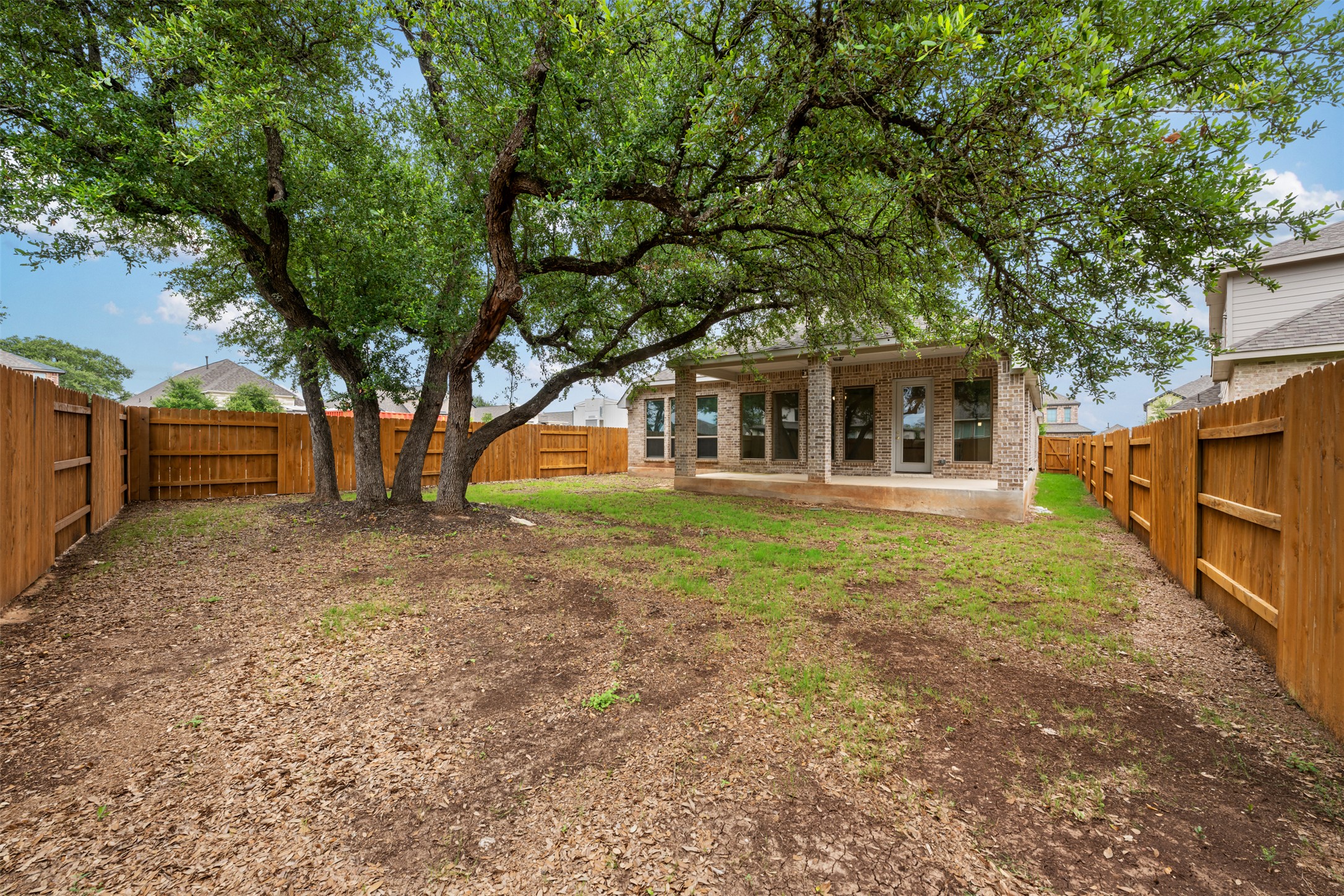 104 Anejo Bluff Georgetown, TX 78628 - Photo 35 of 40 a front view of a house with large trees
