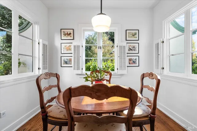 a dining room with furniture and window