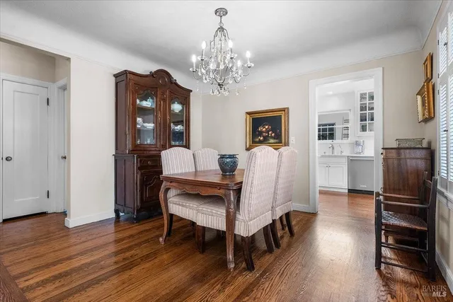 a view of a dining room with furniture wooden floor and chandelier