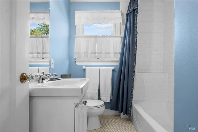 a bathroom with a sink a toilet and tub