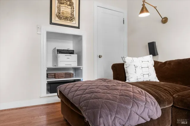 a bedroom with a bed and painting on the wall