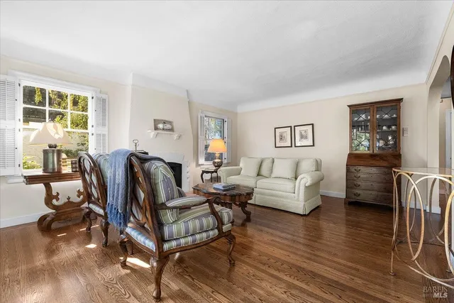 a living room with furniture a wooden floor and a large window