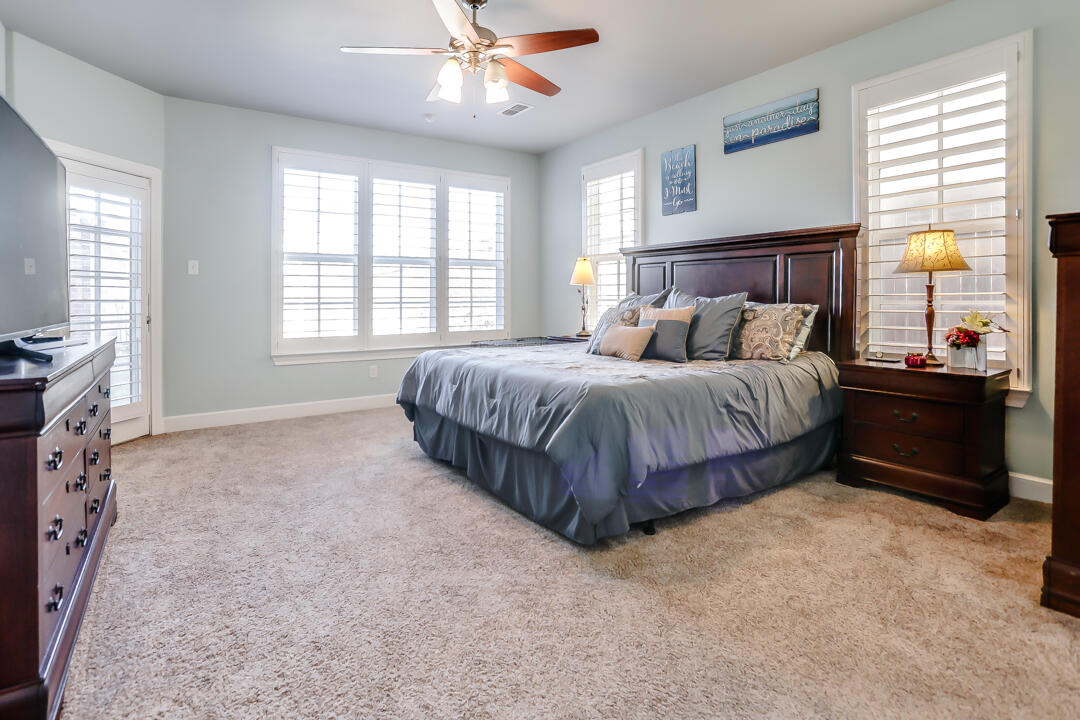 4712 121st Street Lubbock, TX 79424 - Photo 13 of 46 a bedroom with a bed dresser and a window